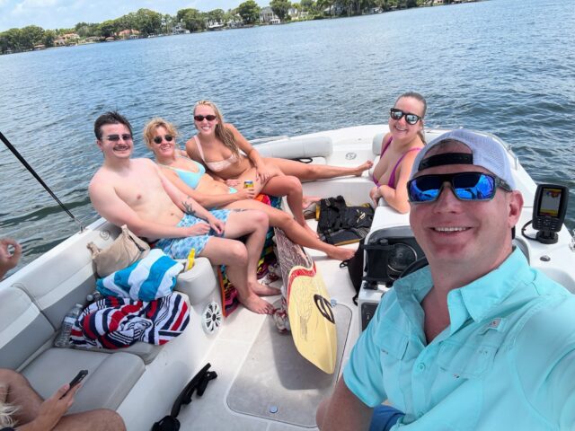 Happy customers on a pontoon boat rental delivered to an Orlando dock by Captain Mike