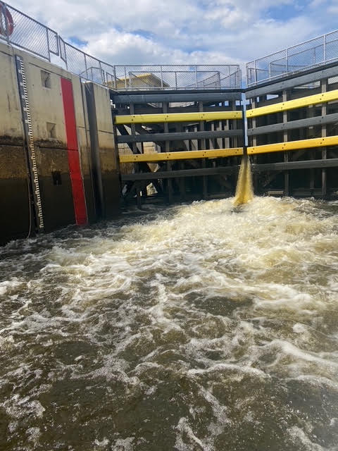 Water rushing through a lock gate on the Kissimmee River leading into Lake Okeechobee, part of the cross-Florida Okeechobee Waterway.