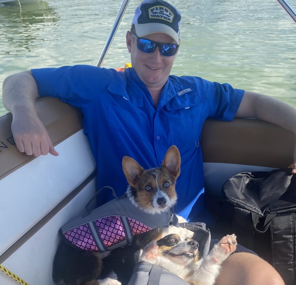 Two dogs riding on a pontoon boat rental in Orlando, Florida