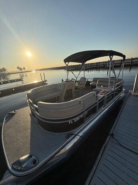 21ft Lowe pontoon tied to the dock at sunrise on West Lake Toho